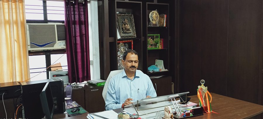 Dr. Rajesh Kumar Singh, Principal, in his office at Parmarth Institute